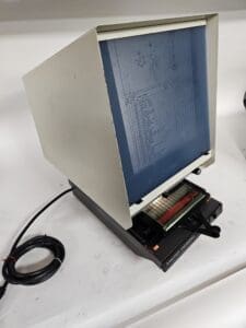 Microfiche reader displaying technical document.