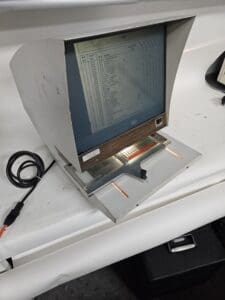 Vintage computer terminal with display and keyboard.